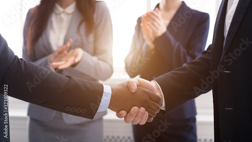 Handshake at business meeting after sealing deal photo