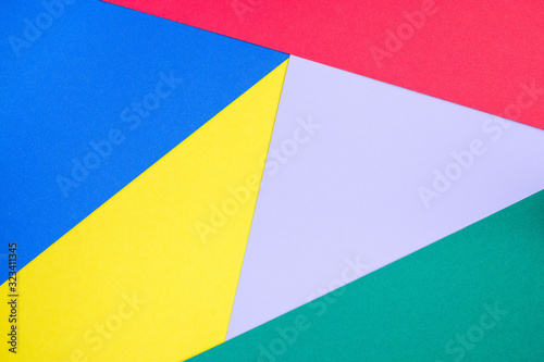 Abstract geometrical pattern made from green, violet, blue, red and yellow paper, blank background for template, horizontal, copy space