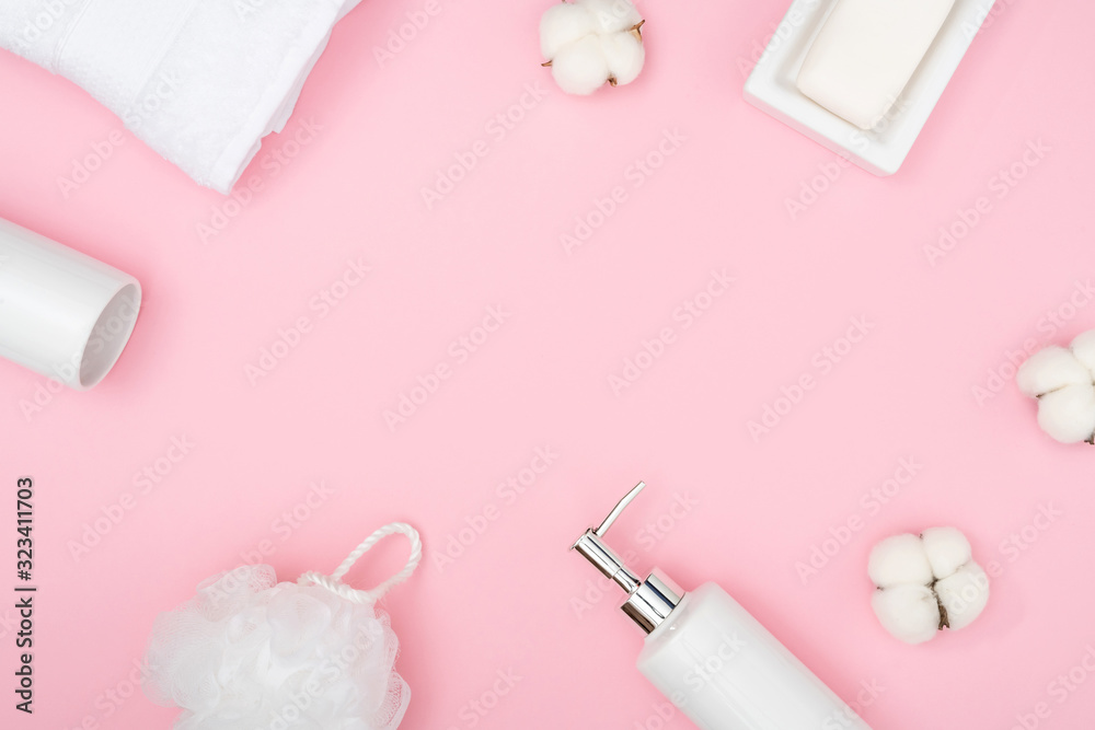 Accessories for bathroom. White towel, soap for bathroom on pink background. Flat lay, top view, copy space