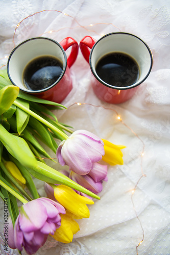 Beautiful morning  two cups of coffee and a bouquet of bright tulips.
