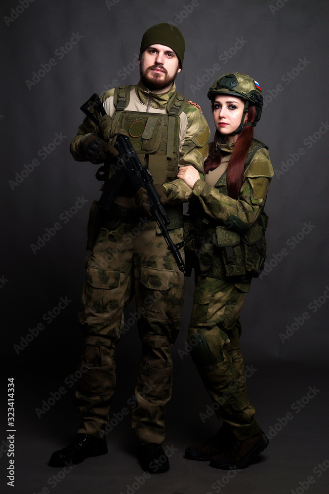 Twol soldiers in camouflage clothing poses in a Studio Twol soldiers in camouflage clothing poses in a Studio