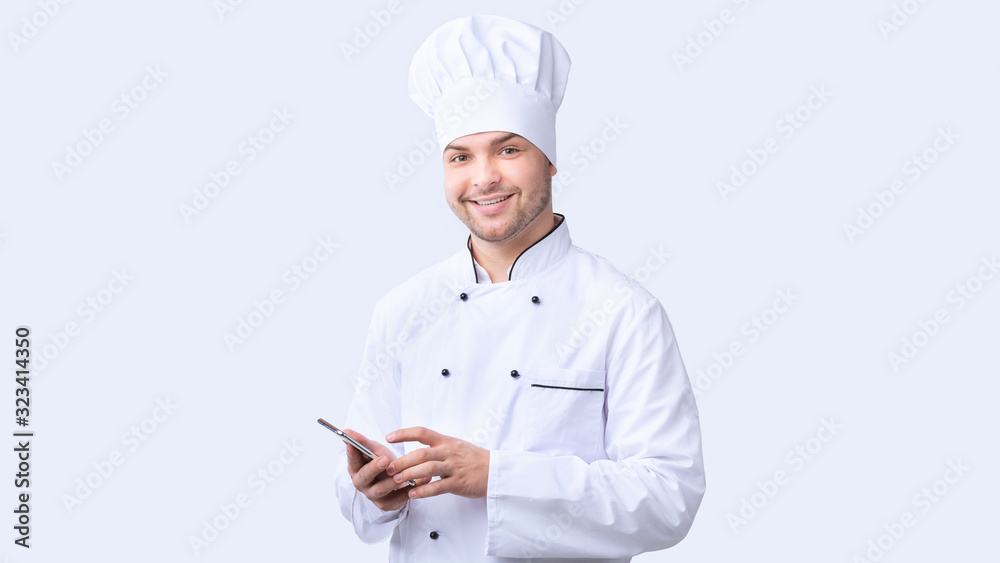 Chef Man Using Smartphone Standing Over White Background, Panorama Chef Man Using Smartphone Standing Over White Background, Panorama