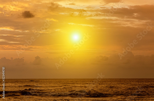 Dramatic sunset sky with red yellow clouds over ocean in Sri Lanka island