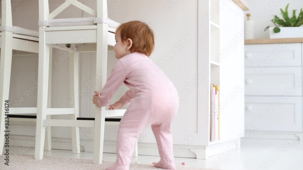 cute little baby girl walking around the living room, one year old cute little baby girl walking around the living room, one year old