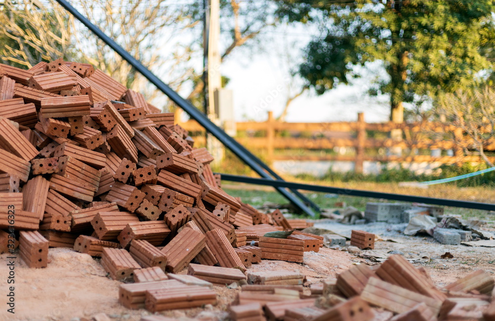 closup group of red bricks on construction site  with soft-focus and over light in the background