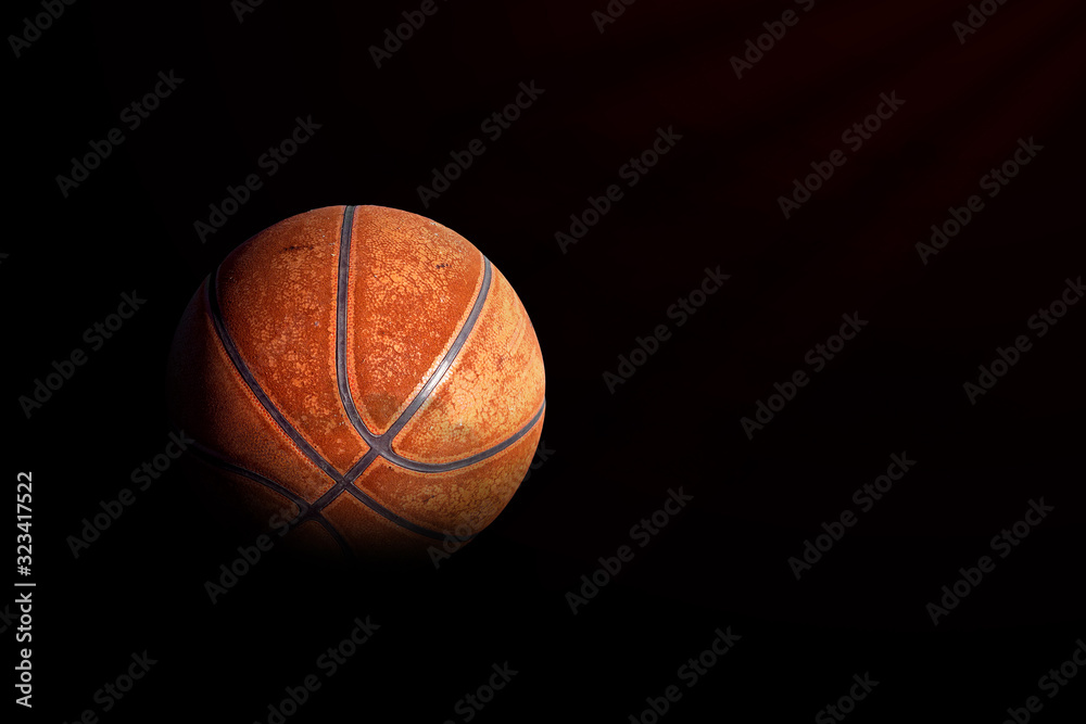 sport concept. old basketball on black background