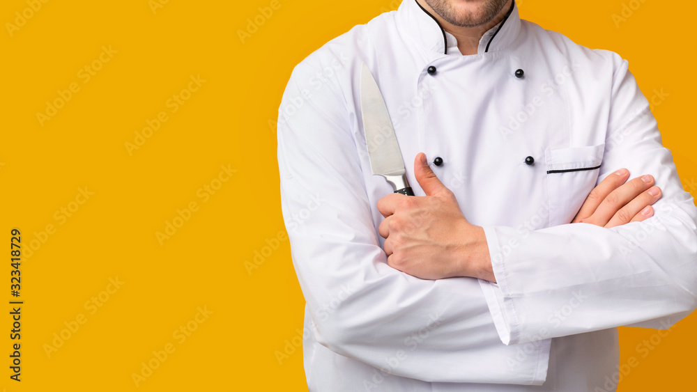 Unrecognizable Cook Man Holding Kitchen Knife On Yellow Background, Cropped