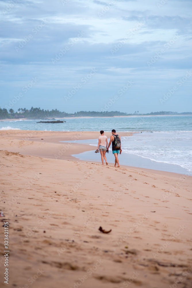 Tangalle, Sri Lanka : 2020 NOV 25 : Young People walk the beach in Sunset in the beach of Tangalle, Sri Lanka. Tangalle, Sri Lanka : 2020 NOV 25 : Young People walk the beach in Sunset in the beach of Tangalle, Sri Lanka.