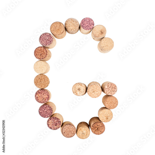 The letter "G" is made of wine corks. Isolated on white background