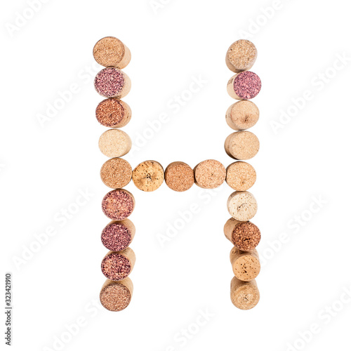 The letter "H" is made of wine corks. Isolated on white background