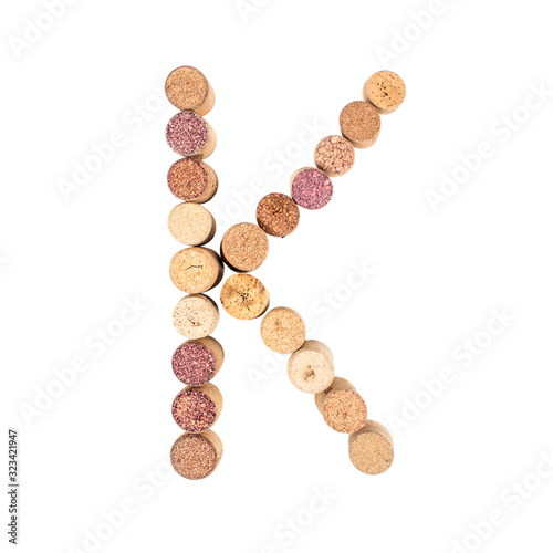 The letter "K" is made of wine corks. Isolated on white background