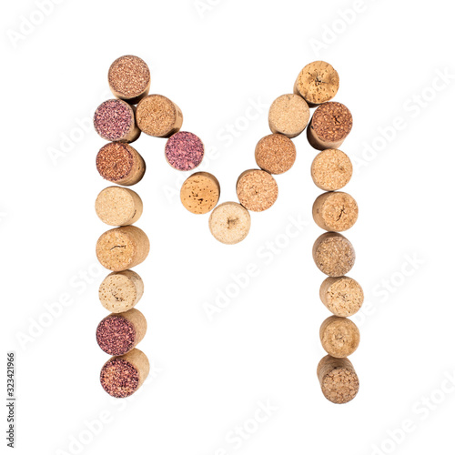 The letter "M" is made of wine corks. Isolated on white background
