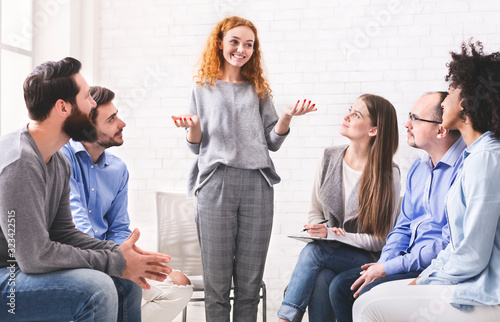 Fototapeta Naklejka Na Ścianę i Meble -  Young woman telling how she overcame drug addiction at group meeting