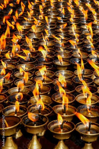 many tea lamps in Nepali temple © SearchingForSatori