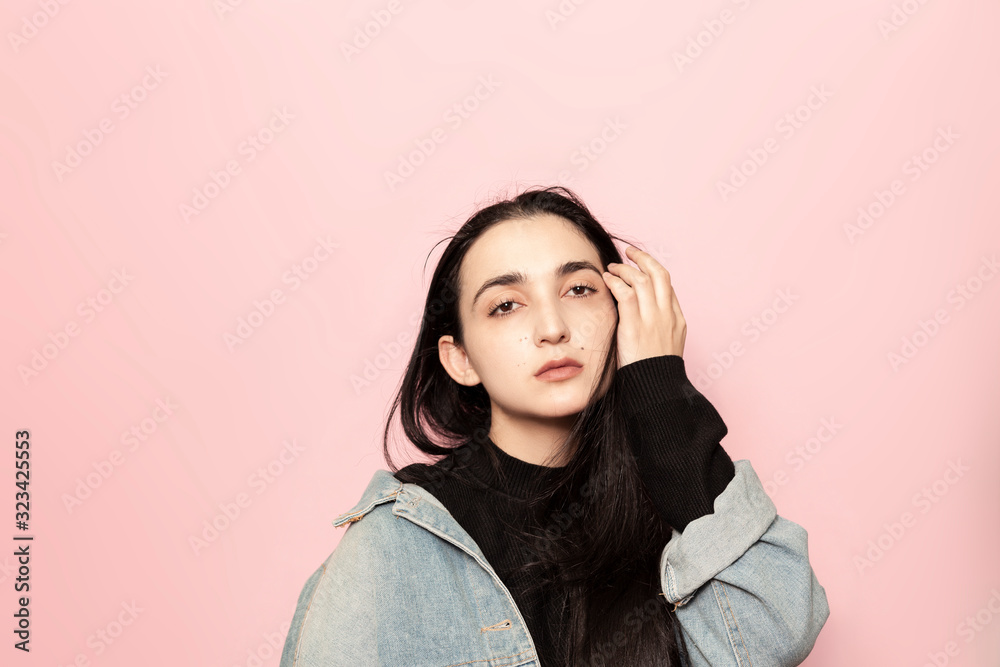Portrait of happy middle-eastern female posing against a pink background. Studio portrait of a stylish young woman. Beauty, fashion, seasonal vogue style weeks concept Portrait of happy middle-eastern female posing against a pink background. Studio portrait of a stylish young woman. Beauty, fashion, seasonal vogue style weeks concept