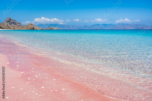pink beach with clear blue water on komodo islands in indonesia photo
