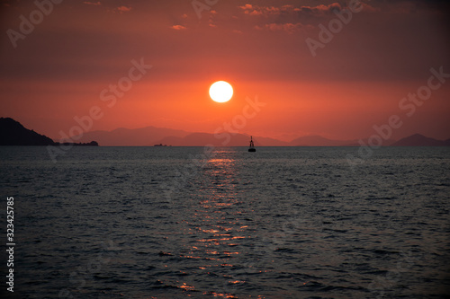 sunset over the sea with boat at horizont