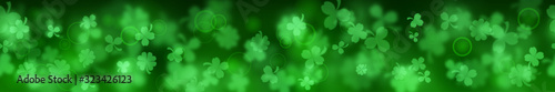 Banner on St. Patrick's Day made of blurry clover leaves in green colors with seamless horizontal repetition