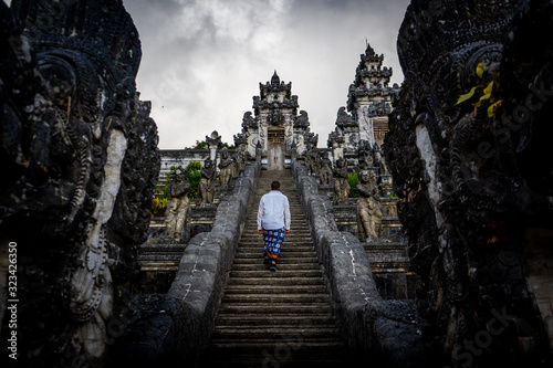 man goes up the stairs to temple photo