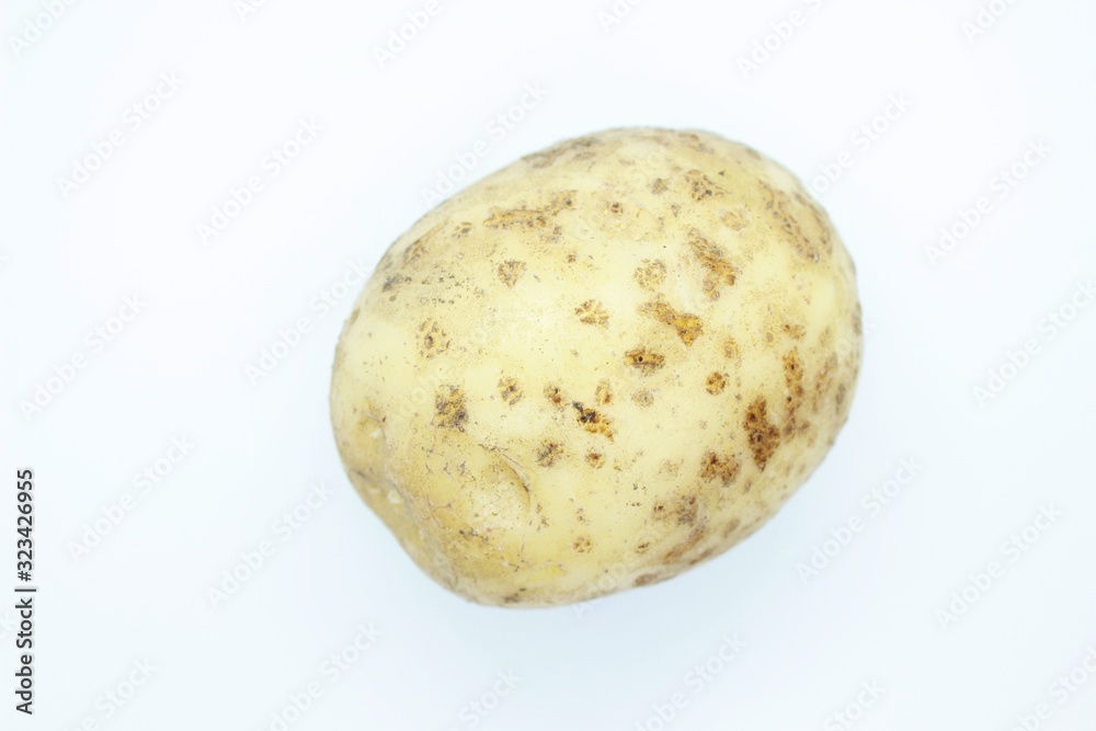 Unpeeled potatoes perched on a white background Unpeeled potatoes perched on a white background