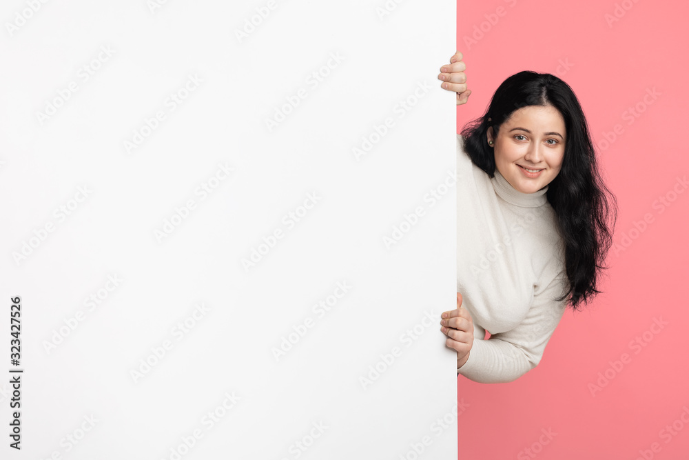 Happy plump girl holding big white advertisement board with free space Happy plump girl holding big white advertisement board with free space