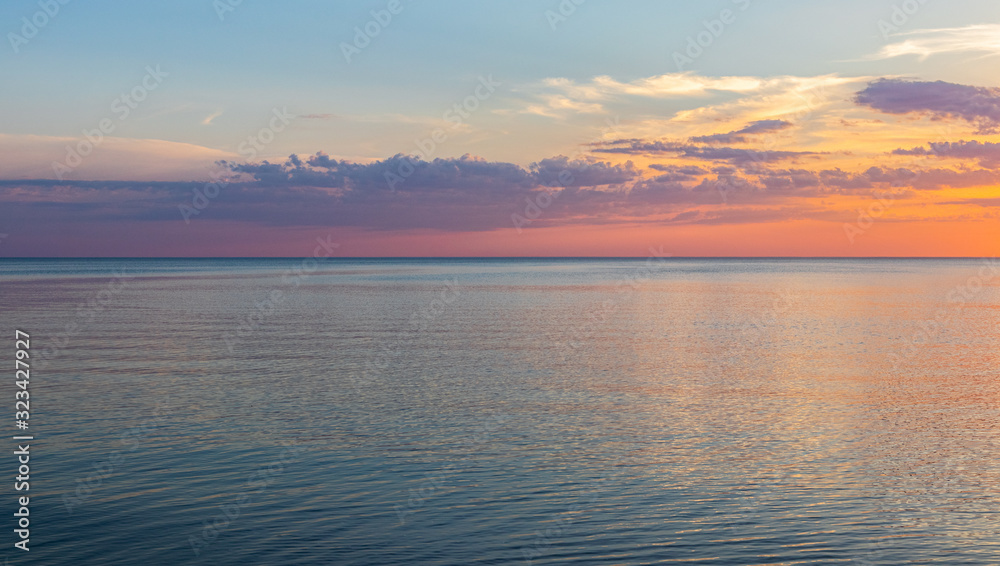 Fototapeta premium Beautiful, colorful sunset on the shore of the Baltic Sea on a warm summer evening. Colorful skies and clouds