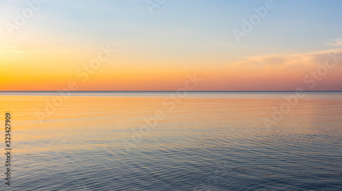 Beautiful, colorful sunset on the shore of the Baltic Sea on a warm summer evening. Colorful skies and clouds