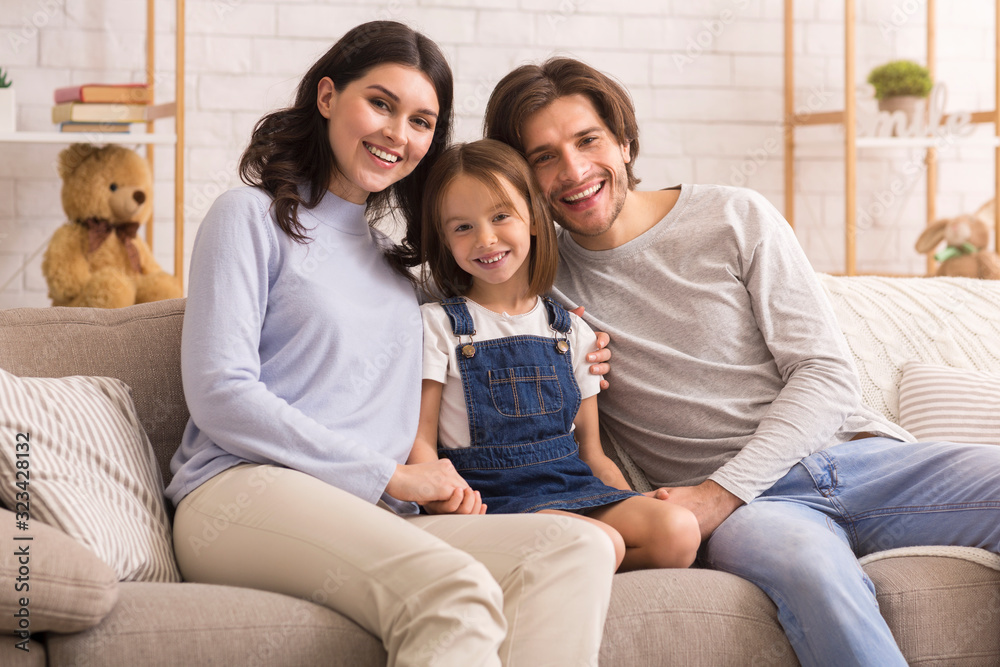 Portrait of cute little girl posing at home with her parents Portrait of cute little girl posing at home with her parents