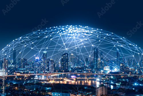 the abstract image of the cityscape image overlay with the futuristic network hologram. the concept of 5G, communication, network, connection, internet of things. photo