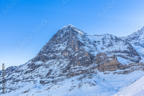 Stunning close up view of Eiger north face from Kleine Scheidegg on a winter sunny day, famous mountain of Swiss Alps on Bernese Oberland near Jungfrau, Interlaken, Switzerland