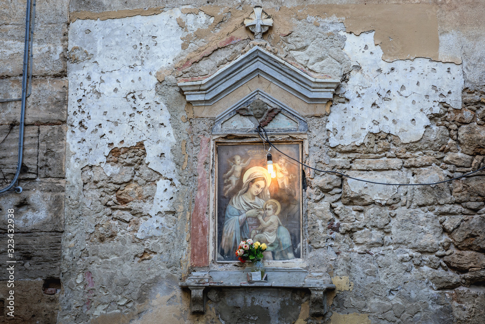 Small Roman Catholic shrine on a building wall in Palermo, Sicily Island in Italy Small Roman Catholic shrine on a building wall in Palermo, Sicily Island in Italy
