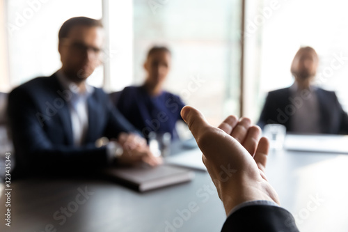 Close up businessman holds out helping hand.