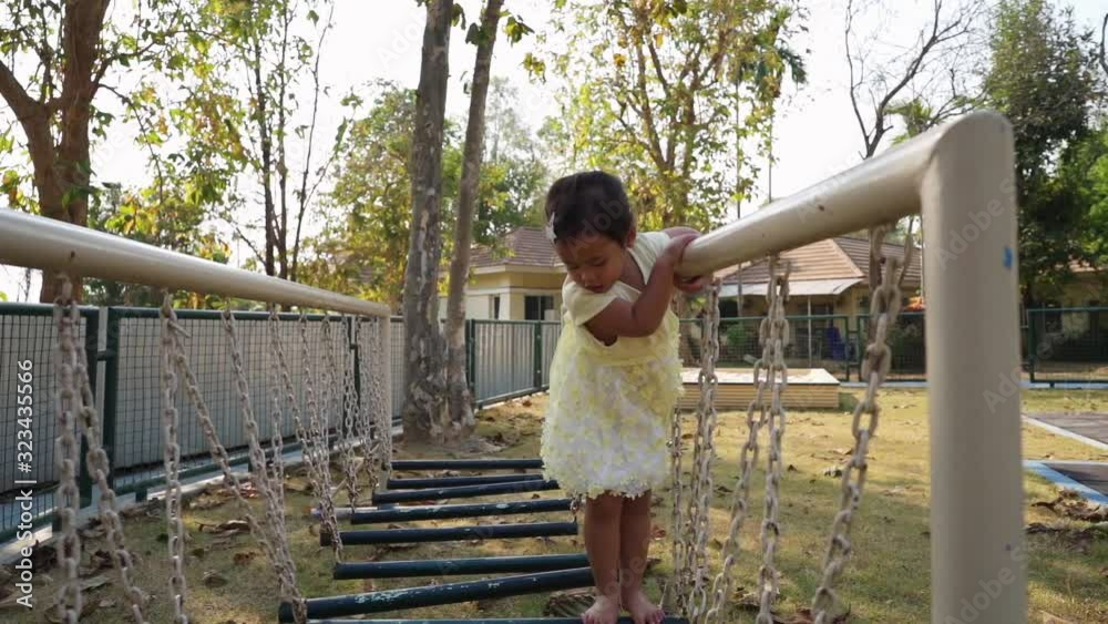 Cute Little playing at playground on sunny day, slow motions Cute Little playing at playground on sunny day, slow motions