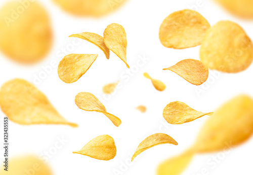 Potato chips levitate on a white background