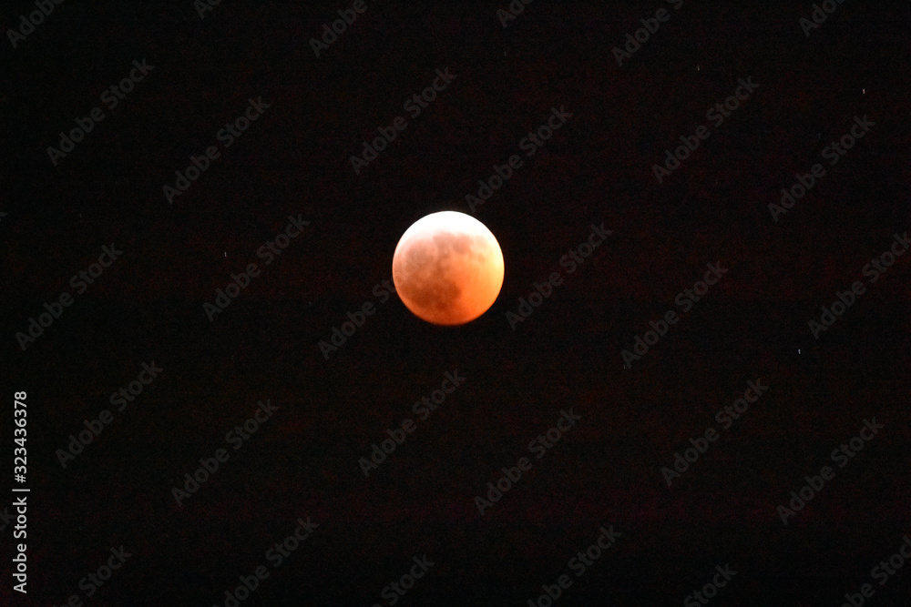 A Shot of a Red Supermoon on Black