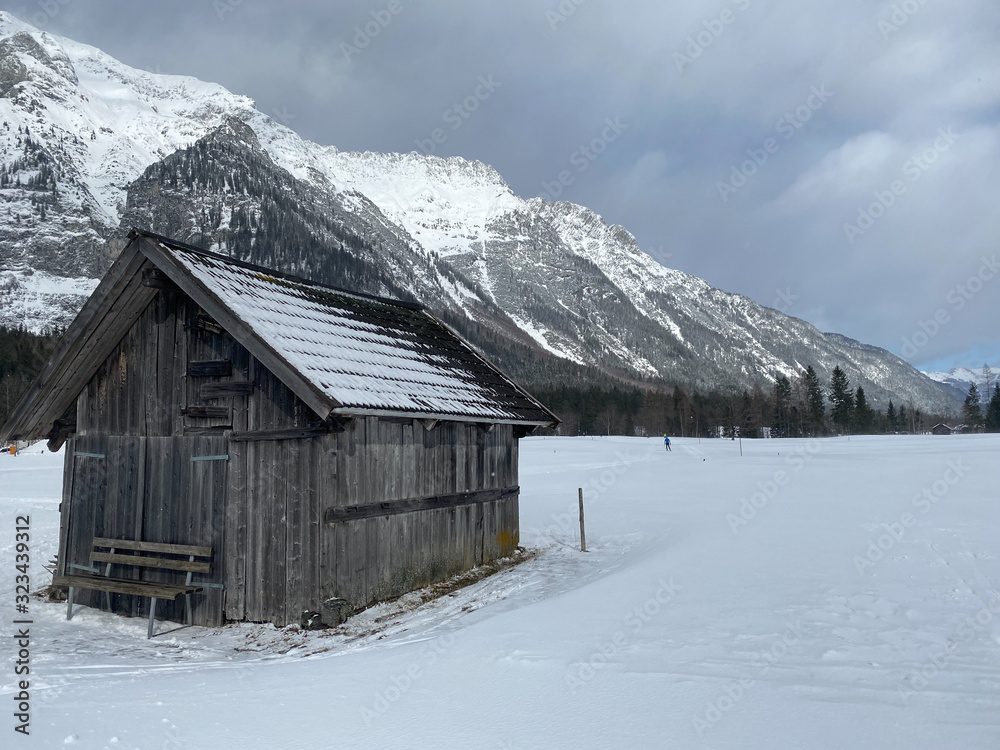 Winter mountains landscape with wooden barn Leutasch, Austria.