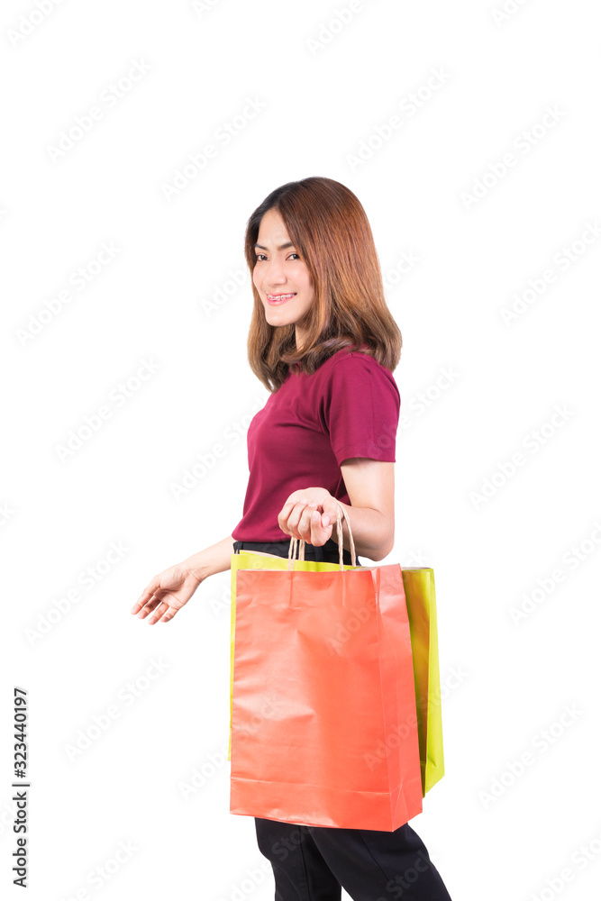 young woman pretty smiling holding paper bags green and orange shopping. on white background and looking at camera young woman pretty smiling holding paper bags green and orange shopping. on white background and looking at camera