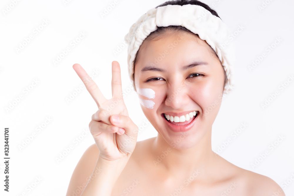 Asian woman apply cream, lotion to beautiful skin on face after bath. Pretty young asian girl make symbol of victory by using finger make symbol of V Attractive beautiful woman get happy, smile face Asian woman apply cream, lotion to beautiful skin on face after bath. Pretty young asian girl make symbol of victory by using finger make symbol of V Attractive beautiful woman get happy, smile face