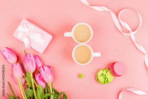 View from above tulips and gift box with confetti and copy space. Background for womens day, 8 March Valentines day, 14 february. Flat lay style, top view, mockup, template, overhead. Greeting card