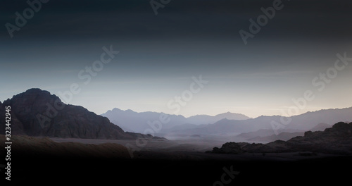 night desert landscape with rocky mountains and sunset sky with clouds in Sharm El Sheikh
