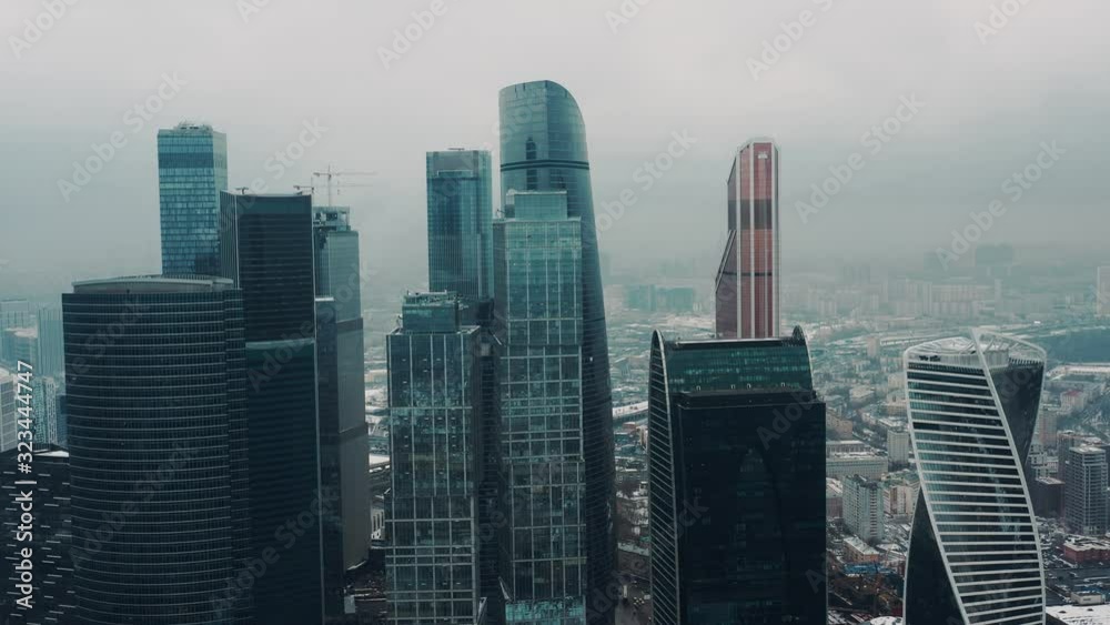 Aerial drone shot flying over center of Moscow city buildings, skyscrapers at cloudy winter day. Drone shot flying over Moscow skyscrapers. Aerial drone shot flying over center of Moscow city buildings, skyscrapers at cloudy winter day. Drone shot flying over Moscow skyscrapers.