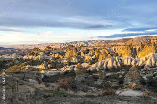 Rocky landscape of Kiliclar valley with many colorful taxtures during sunset with no people and balloons. Geological formations of Cappadocia.