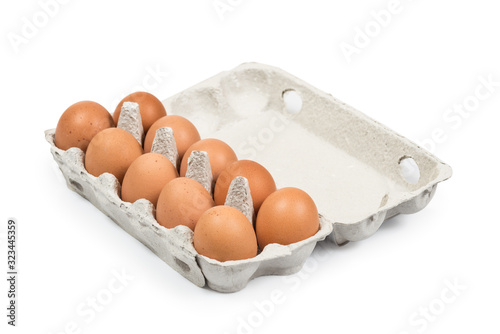 Ten Brown eggs in the cardboard package box high angle view isolated