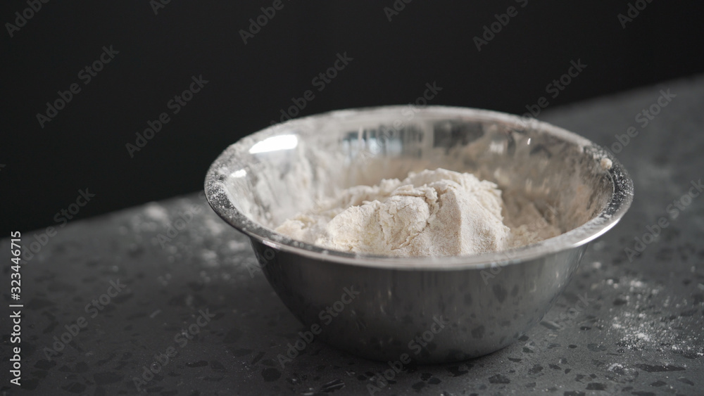 dough in steel bowl on concrete countertop dough in steel bowl on concrete countertop