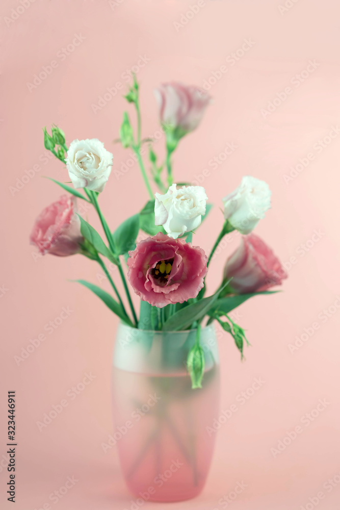 bunch of white and pink eustoma flowers in glass vase