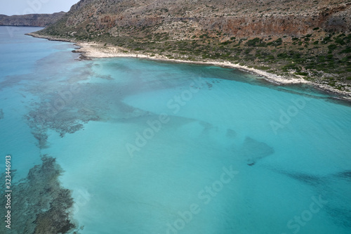 Amazing aerial drone top panoramic view on the famous Balos beach in Balos lagoon and pirate island Gramvousa. Place of the confluence of three seas. Balos beach, Chania. Crete island. Greece. Europe. © Mindaugas