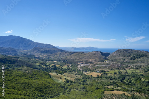 Unique panoramic aerial view of rural region landscape. Green meadows, olive tree groves, and vineyards, in spring Crete, Greece.
