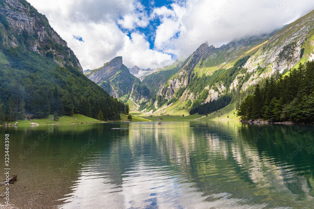 Stunning panorama view of Alpstein massif with Santis (Saentis) on Seealpsee lake side on a sunny summer day, with blue sky cloud, Canton of Appenzell, Switzerland Stunning panorama view of Alpstein massif with Santis (Saentis) on Seealpsee lake side on a sunny summer day, with blue sky cloud, Canton of Appenzell, Switzerland
