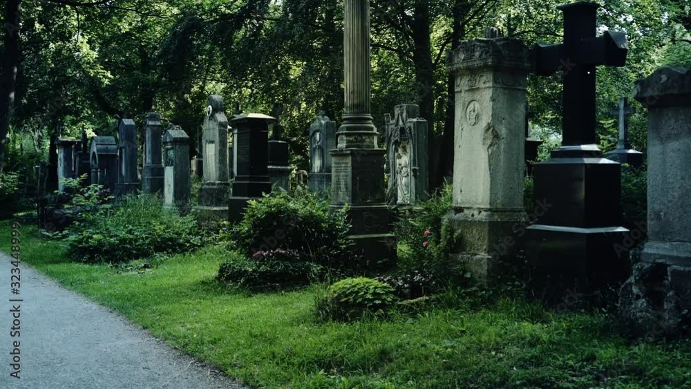 Mysterious Walk around graves in European old cemetry. The concept of horror and suspense Mysterious Walk around graves in European old cemetry. The concept of horror and suspense
