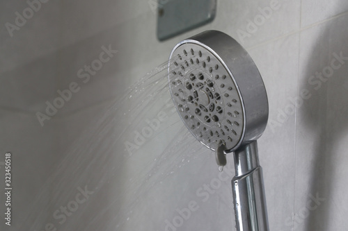 Water that flows out of the shower gently. Water flows out of the shower. photo
